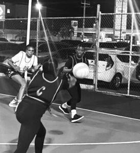 World Ward 1 Center attempts to catch the ball at the goal circle blocking attempt from South Camp Road Rebels. Game day was at the Scotia Sports club on Friday December 12, 2025 during the Sutherland SPICE Netball Competition