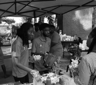 Productions and Operations Management Seminar from the School of Business at the Utech Papine Campus on November 27th, 2025. Members taking orders Man and Woman handling food and taking orders in black and white